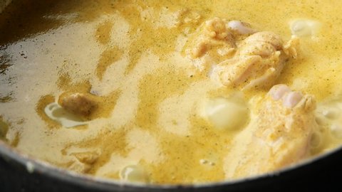 Close-up Cooking of Chicken Green Curry in pan. Local Thai food.