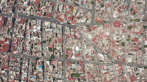 Colorful, vibrant red roof of buildings in latin city suburban district. Top down view on Mexico city, 4K drone aerial. Exploring town in Central America. Latin America country adventure travel video