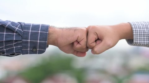 Two business man hands use fist bump for succes teamwork corporate