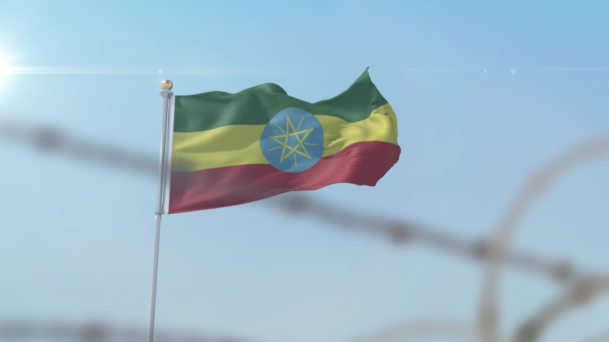 Flying flag of Ethiopia behind barbed wire fence. Conceptual  3D animation Royalty-Free Stock Footage #1057625653