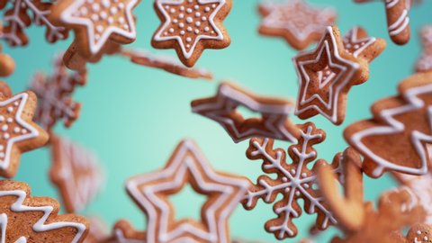 3d Christmas biscuits in the shapes of snowflakes and stars with icing, gingerbread cookies falling and rotating, isolated on blue background. Holiday animation with motion blur