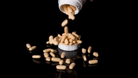 Prescription Drug Container Pouring Pills into a Cap, Slow Motion