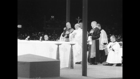 CIRCA 1965 - Children receive communion from Pope Paul VI at a special nighttime mass held at New York's Yankee Stadium.