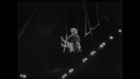 CIRCA 1957 - The Flying Alexanders perform on the trapeze among other aerialists at a Ringling Brothers Circus performance.