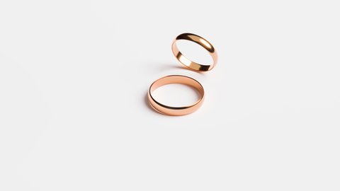 Wedding Golden Rings isolated on white background. Footage to Jewelry for Marriage with copy space and time at start of video for making transition in good quality.
