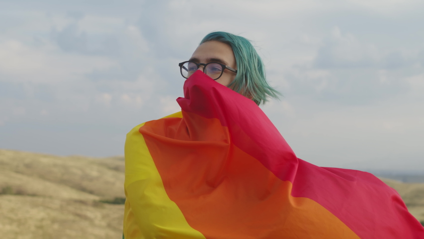 Side view of the wheel of a bicyclist riding on the highway against the background of the sunset. Close-up of male legs of a cyclist pedaling on a Bicycle, riding on the side of the road