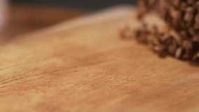 Very Close-up, 900 fps video.In a beautiful light, Green lentil grains fall into the wooden plate in slow motion.Macro,Phantom Camera.