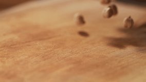 Very Close-up, 900 fps video.Chickpea grains on a delicious background and wood floor passes in front of the camera in slow motion.Macro,Phantom Camera.