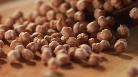 Very Close-up, 900 fps video.Chickpea grains on a delicious background and wood floor passes in front of the camera in slow motion.Macro,Phantom Camera.