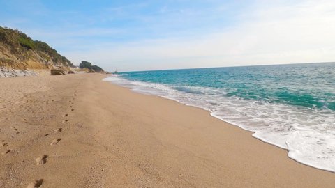 walking,walking in the sand,calm mediterranean sea,barcelona spain, footprints in the sand