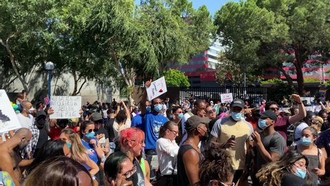 Los Angeles , California / United States - 06 14 2020: Pan Over Crowd With LGBT and Black Lives Matter Signs, People Dancing During Annual Los Angeles Pride in West Hollywood