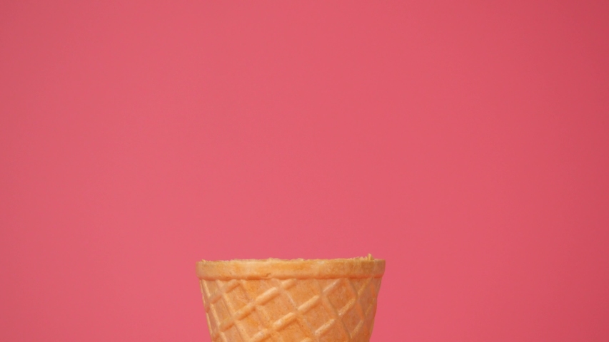 Ice cream Cookies & Cream scoop in waffle cone on pink background, Front view Food concept. Royalty-Free Stock Footage #1057662739