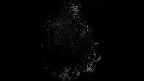 A big bubble ring falling from the top and exploding at the center on a black background from the Submerge collection - Water VFX Video Element.