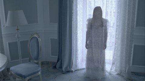 Ghost of bride in white dress stretching out hand, demonic force, witchcraft