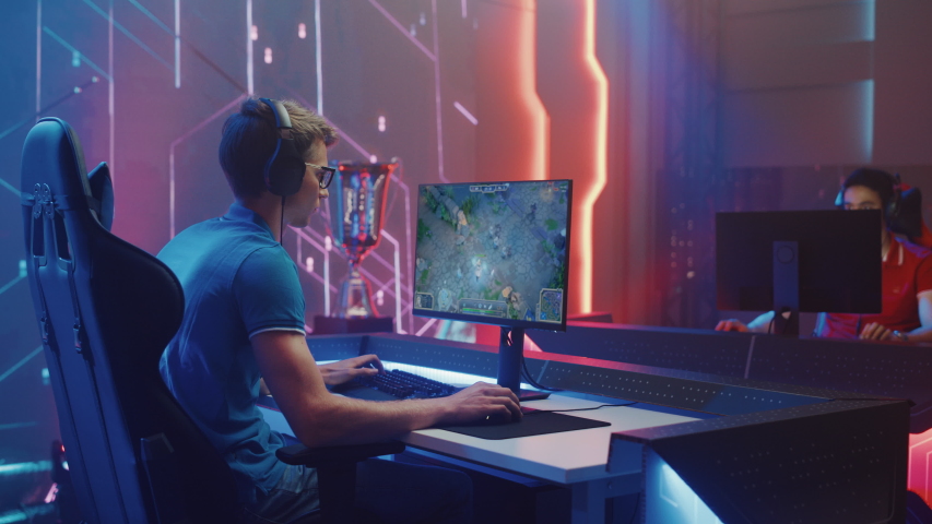 Professional eSports Gamer Plays RPG MOBA Mock-up Video Game with Fun Special Effects on Computer at Championship Event. Online Cyber Tournament. Arc View Medium Shot Royalty-Free Stock Footage #1057670281