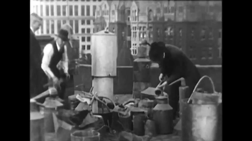 CIRCA 1920s - Lawmen use hatchets to smash up alcohol stills seized during prohibition, in 1924. Royalty-Free Stock Footage #1057672108