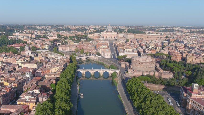 Aerial view of Rome, Castel Sant'Angelo (Castle of the Holy Angel) in foreground and Vatican City in background, bridges over river Tiber - cityscape of capital city of Italy from above, Europe Royalty-Free Stock Footage #1057672996