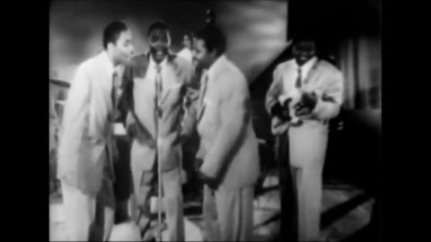 CIRCA 1956 - In this musical revue at the Apollo Theater, R&B doo-wop group The Clovers conclude a performance of "Lovey Dovey."