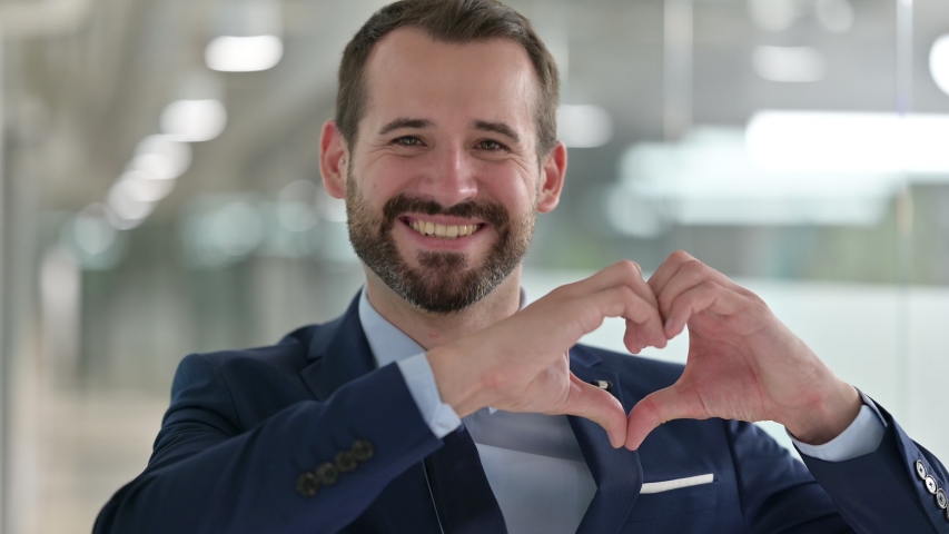 Portrait of Happy Businessman showing Heart Sign with Hand | Shutterstock HD Video #1057676185