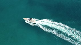 Aerial drone tracking video of speed boat cruising in high speed in deep blue Aegean sea