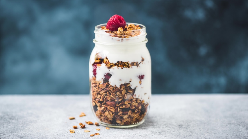 Stop motion animation Healthy breakfast granola parfait with greek yogurt and raspberries | Shutterstock HD Video #1057682791