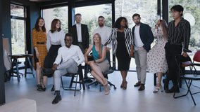 Big team portrait of happy young multiethnic business colleagues looking at camera posing for photo at modern office. - Powered by Shutterstock - Get 15% off with code: PIKWIZARD15