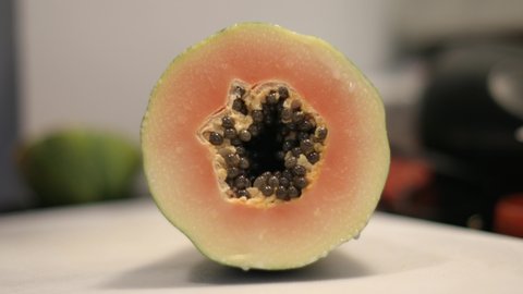 Narrow focus close-up: Slicing ripe orange papaya fruit with seeds ஸ்டாக் வீடியோ