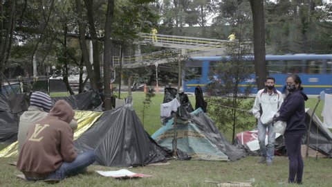 Bogota / Colombia - 06 25 2020: Officials disinfect bridge by Venezuelan migrant camp in Bogota, Colombia
