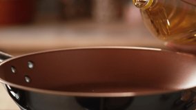 Oil is pouring into the pan.Very Close-up, 900 fps video