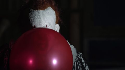 Evil Clown Make Up, Scary Halloween Horror Scene, Frightening with Balloon.