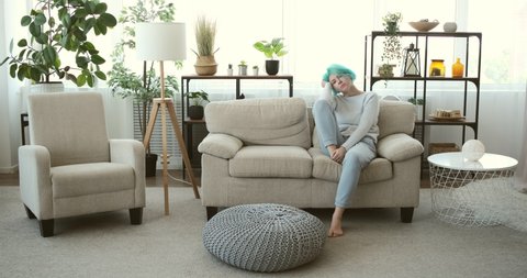 Depressed woman trying to relax on sofa at home