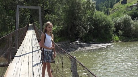 Kid on Bridge at Camping in Mountains Trails, Child Hiking in Excursion, Young Blonde Girl Looking a River, Stream in Nature
