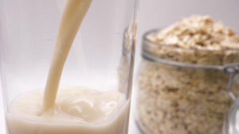 Pouring Vegan Friendly Oat Milk Close Up Slow Motion