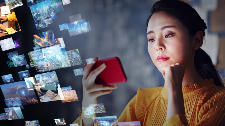Young asian woman watching a lot of movies. Digital transformation. Royalty-Free Stock Footage #1057713157