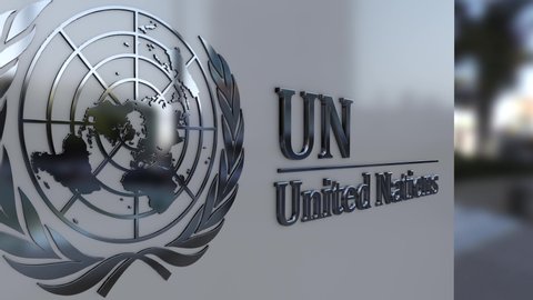 Metal United Nation emblem on a building facade, UN logo. 