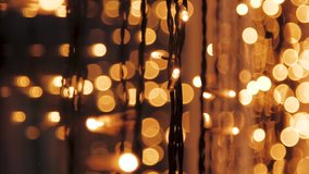 Decorative golden string lights hang and glow at evening, vintage garland of lamps, warm lighting, electric bulbs shining, decoration for holiday or christmas, blurry out of focus bokeh background - Powered by Shutterstock - Get 15% off with code: PIKWIZARD15