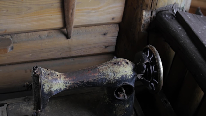 Knitting machine. Sewing equipment. Cloth production. Old sewing. History of manufacture. Metal wheel. Antique machine. Metal knitting tool.