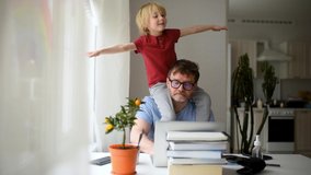 Man working from home with laptop during quarantine. Home office and parenthood at the same time. Exhausted parent with hyperactive child. Chaos with kids during isolation	 - Powered by Shutterstock - Get 15% off with code: PIKWIZARD15