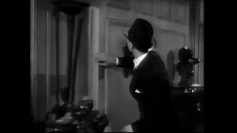 CIRCA 1939 - In this classic horror comedy, a detective discovers secret passageways in a mansion while the maid makes a run for it on a rainy night.