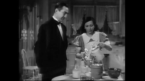 CIRCA 1939 - In this classic horror comedy, a butler (Bela Lugosi) tries to calm a maid (Patsy Kelly) in the kitchen before she is interrogated.