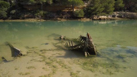 Sunken skeleton boat abandoned in still waters, Static Shot