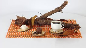 Top view spinning video of coffee pot with wooden branch.