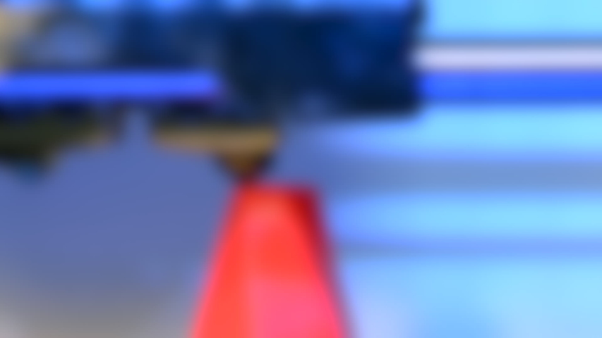 Blurred background. Modern 3D printer printing figure close-up macro. Automatic three dimensional 3d-printer performs plastic pink and blue colors modeling in laboratory.