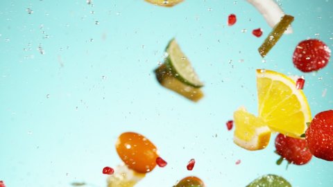 Super slow motion of sliced fruits hitting in the air with water splashes. Filmed on high speed cinema camera, 1000 fps.