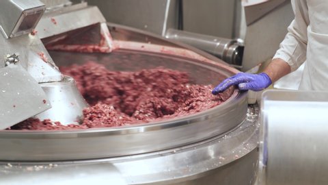 Meat production, the process of making minced pork meat, food production line, mixing minced meat.