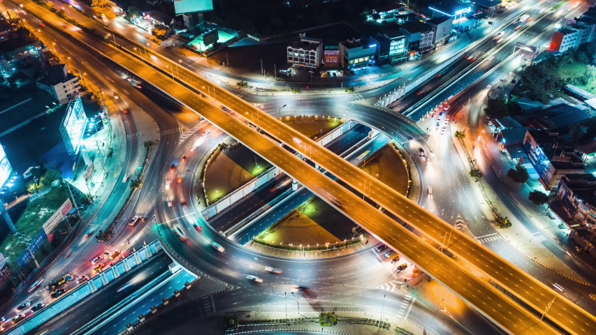 Hyperlapse time-lapse of car traffic transportation above circle roundabout road in Asian city. Drone aerial view fly in circle, high angle. Public transport or commuter city life concept | Shutterstock HD Video #1057759516