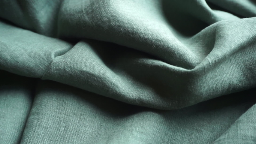 Linen fabric background. Linen textile cloth with fabric texture and pattern. Production of clothing and natural environmentally friendly materials. Royalty-Free Stock Footage #1057760710