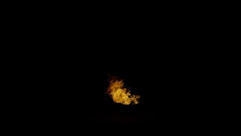 A long fireball spurts from right to left before tapering off on dark background, shot in 4k at 120fps from the ignite collection - Fire VFX Video Element.
