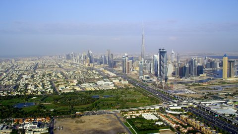 Flying through a panoramic view of the city over the Safa Park anding in close towards the iconic Burj Khalifa, 6-axis stabilized gimbal, Shotover F1, 8K, parallax.