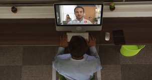 Animation of overhead view of Caucasian man having video chat on computer with Caucasian businessman. Social distancing and self isolation in quarantine lockdown concept digital composition.